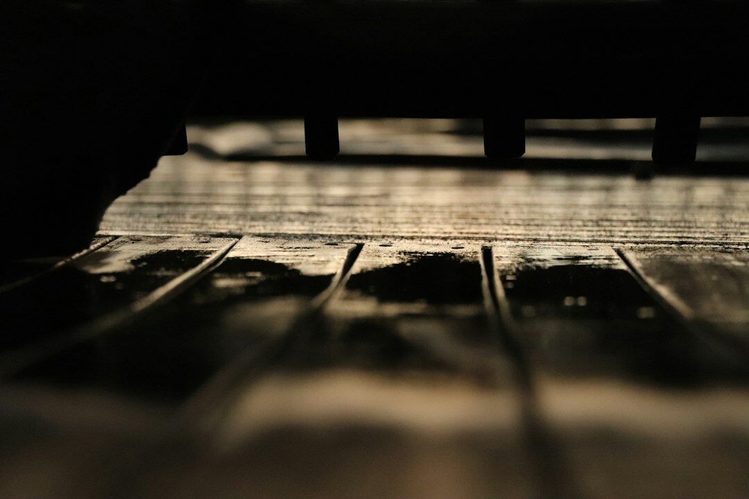 Close-up of a vintage typewriter with a blank sheet of paper under dramatic lighting